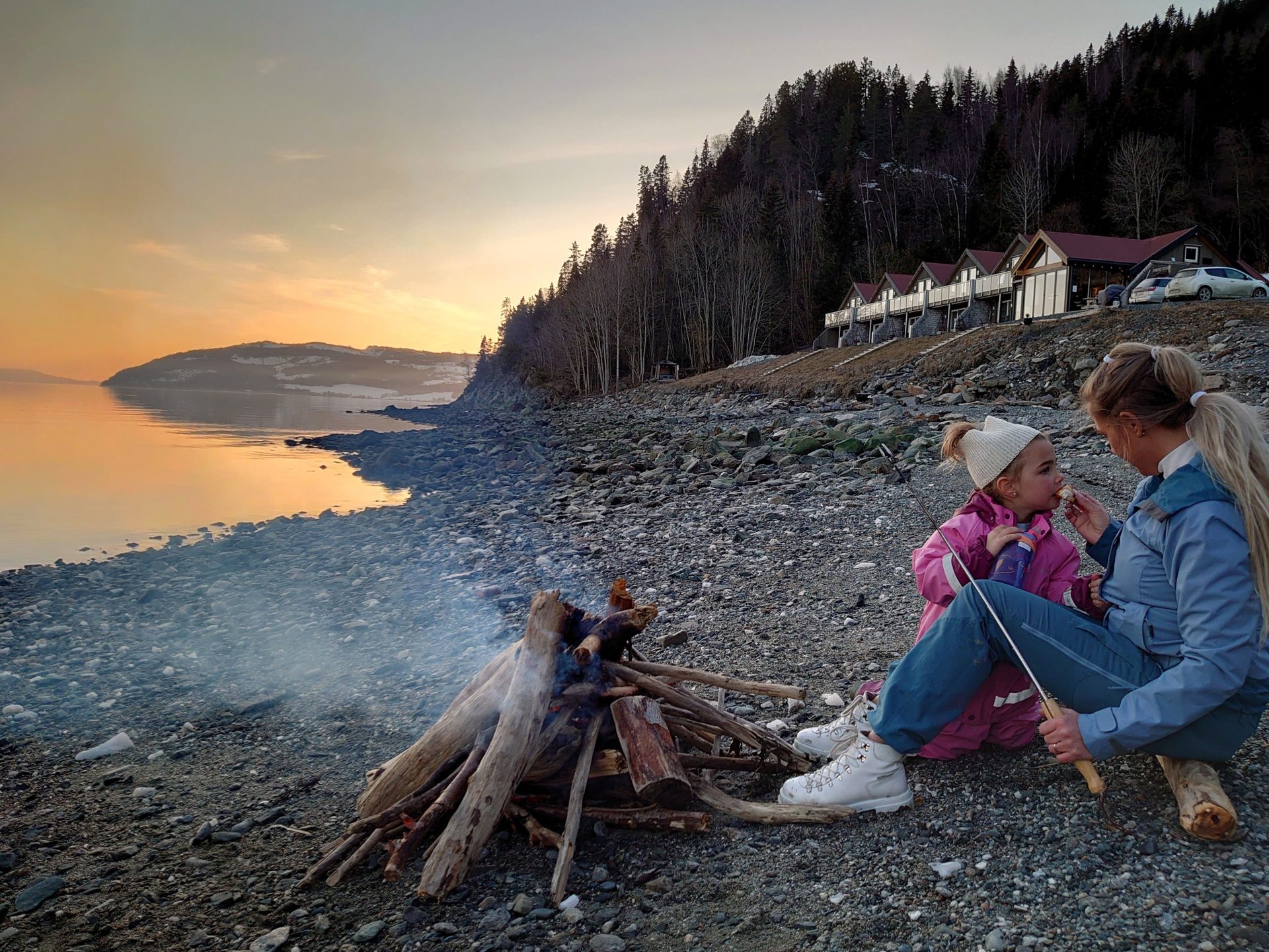 Retreat be sitting on the shore by a fire, like in this photo.